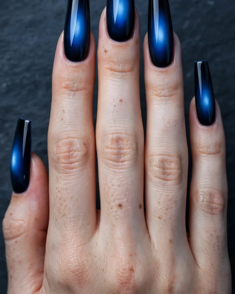 Midnight blue aura nails, navy borders dissolving into sapphire glow on coffin nails
