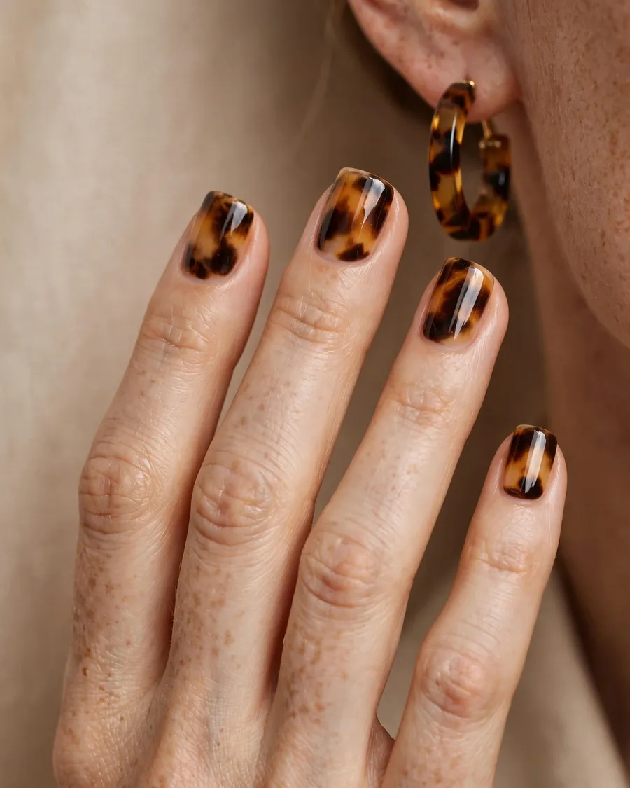 Tortoiseshell pattern short square nails with amber, caramel and dark brown marbling