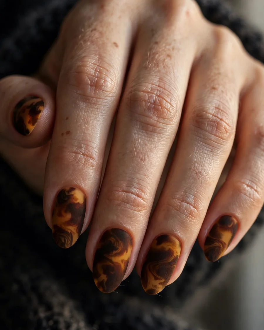 Matte finished tortoiseshell nails with velvety suede texture